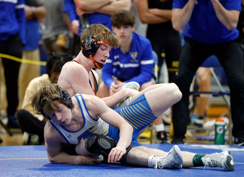 Declan Sons of St. Charles East wrestles Danny Hyde of Wheaton North at 126-pounds during the DuKane Conference boys wrestling tournament Saturday, Jan. 24, 2026 at Wheaton North High School in Wheaton.
