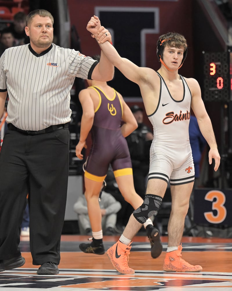 St. Charles East’s Dom Munaretto is declared the winner in the Class 3A 120-pound match at the boys IHSA wrestling finals at State Farm Center in Champaign on Saturday, Feb. 21, 2026.