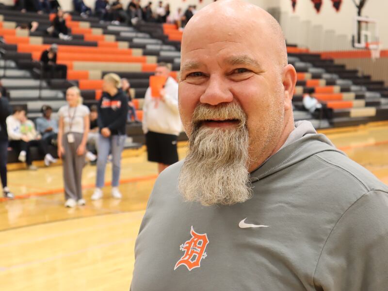 DeKalb School District 428 driver's education instructor and assistant athletic director Mark Sykes reacts to a surprise award ceremony on April 25, 2025, at DeKalb High School, 501 W. Dresser Road. Sykes was named the 2025 Wirtz Award winner for excellence in education.