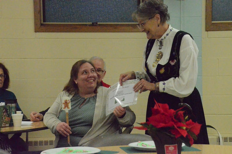 Barb Johnson of Yorkville, right, presents Kelly Welin of Wheaton with a "best cookie baker" certificate and spatula Sunday. Welin's Norwegian spice cookies won a contest sponsored by Sons of Norway Polar Star Lodge 5-472 at St. Olaf Lutheran Church, Montgomery.