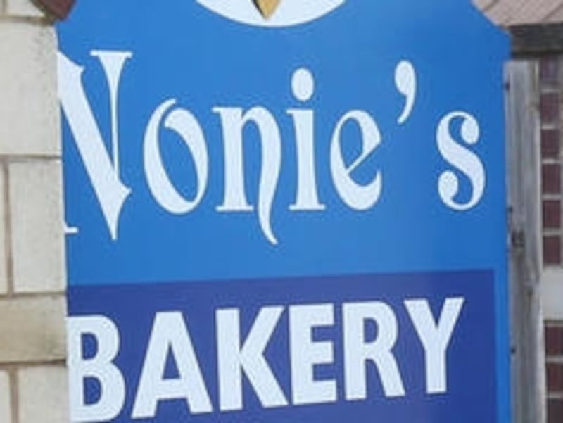 Debbie and Tim Novak, owners of Nonie's Bakery and Cafe, pose for a photo outside their business in Utica.