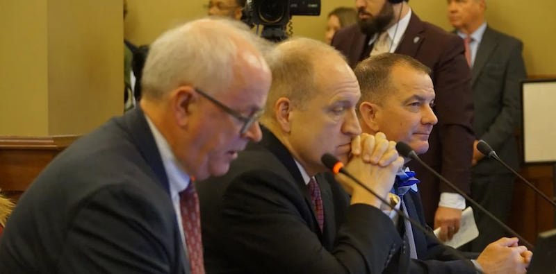 Nicholas Jones, left, executive vice president of the University of Illinois System, testifies before a House Committee opposing a bill to overhaul the way Illinois fund public universities. Also testifying in favor of the bill are Southern Illinois University System President Daniel Mahoney, center, and Eastern Illinois University President Jay Latrell.