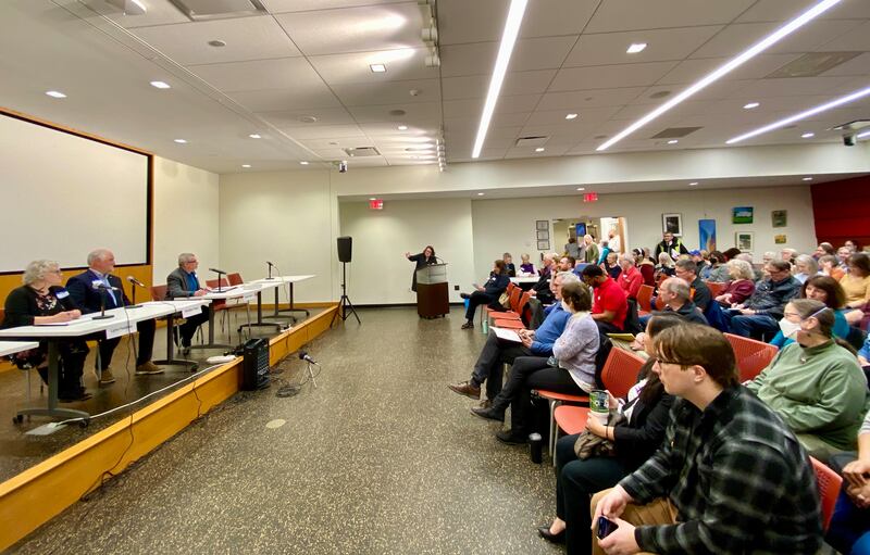 Write-in candidates for the DeKalb City Clerk's Office (from left) Lynn Fazekas, Bradley Hoey and Steve Kapitan, await the start of a candidate forum moderated by WNIJ Radio's Sue Stephens (middle) on Sunday, March 9, 2025, in front of a packed Yusunas Room as the DeKalb Public Library, 309 Oak St.,