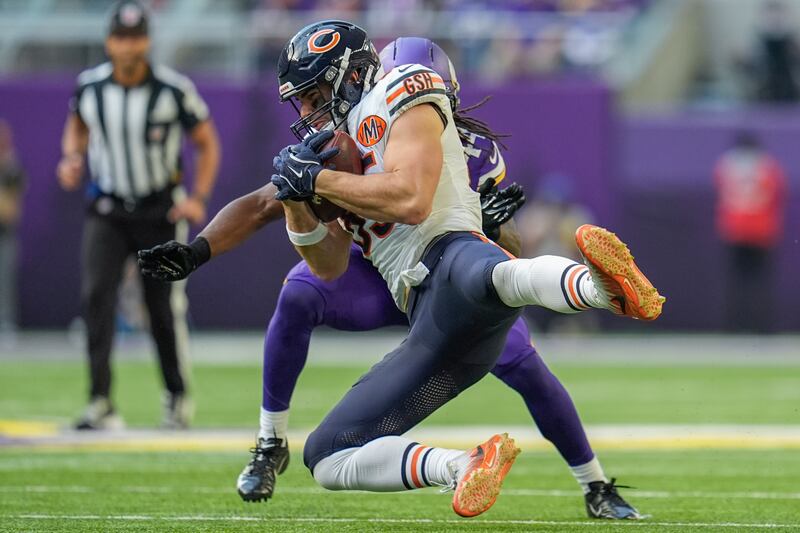 Chicago Bears tight end Cole Kmet (85) catches a pass as Minnesota Vikings safety Joshua Metellus (44) defends during the first half of an NFL football game, Sunday, Nov. 16, 2025, in Minneapolis. (AP Photo/Abbie Parr)