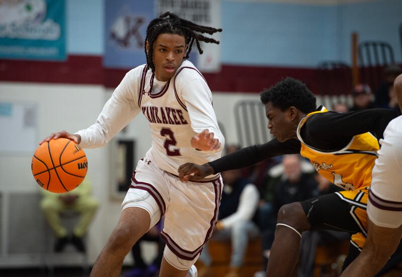 Kankakee's Kenaz Jackson Jr, left, controls the ball against Richards's Reginald Johnson, right, in a game in the Kankakee Holiday Tournament at Kankakee High School on Saturday, December 27, 2025.
