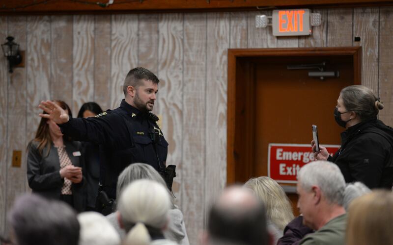 Downers Grove police officers including officer Stults ask people to leave as a result of disturbing the US Rep Sean Casten Downers Grove town hall meeting Wednesday March 19, 2025. The meeting was disruptive several times due to verbal attacks towards Casten and the unrest with Israel and Palestine.