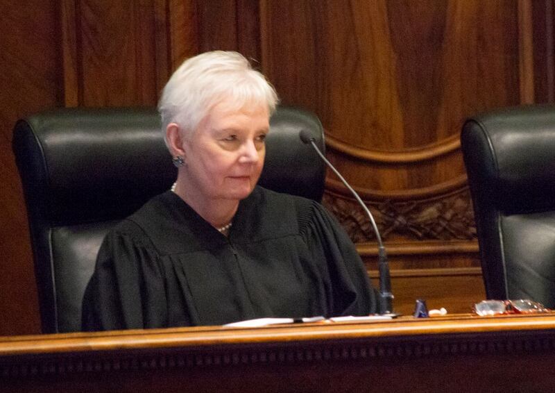 Supreme Court Justice Mary Jane Theis listens to remarks from the bench at the Illinois Supreme Court in Springfield.