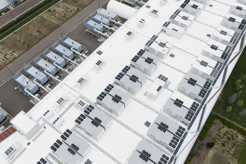 FILE - Fans, part of a cooling system, are visible on the roof of a data center April 27, 2026, in Hillsboro, Ore. (AP Photo/Jenny Kane, File)