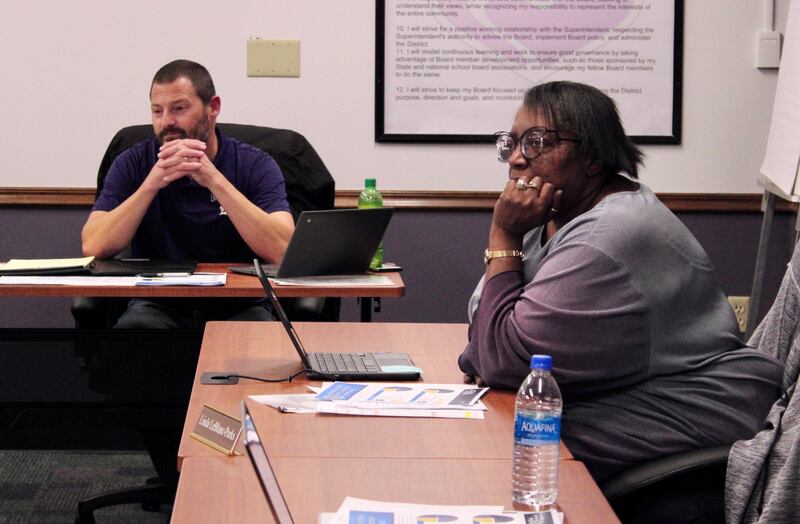 Dixon Public Schools board of education secretary Brandon Rogers and member Linda Leblanc-Parks listen to a presentation on Wednesday, Oct. 19, 2022 at the administrative offices.