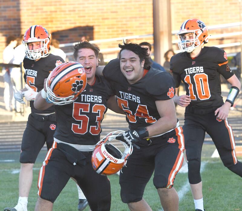 Byron linemen Dalton Norris (53) and Braiden Hammes (54) celebrate after the Tiger's 28-6 win over Elmhurst IC Catholic in 3A quarterfinal action at Byron High School on Saturday, Nov. 15, 2025.