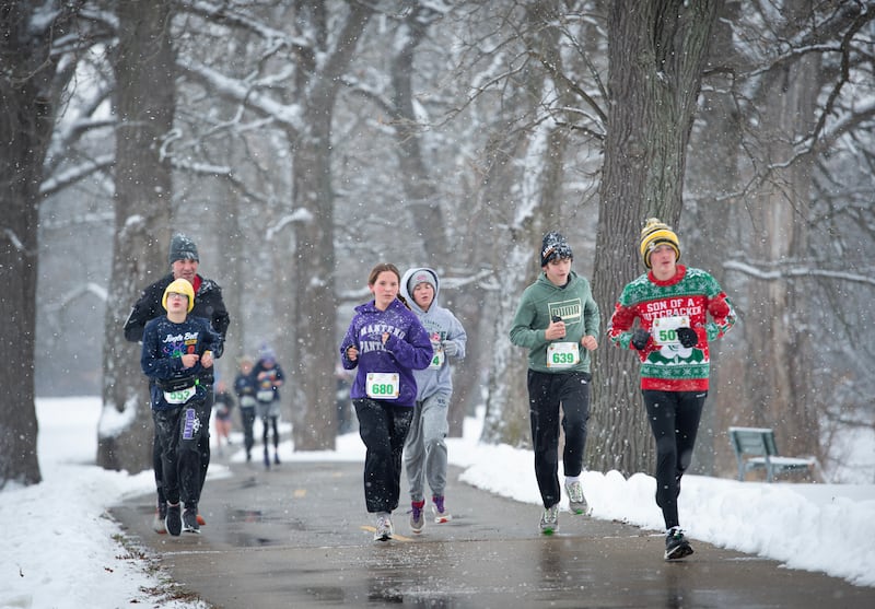 Runners in the 35th annual Jingle Bell Run run along the river at Kankakee Community College on Sunday, December 7, 2025.