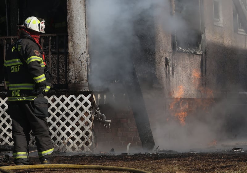 Peru Fire Chief Jeff King, stares at flames coming from a gas line while on the scene of a structure fire in the 800 block of Bucklin Street on Friday, Jan. 23, 2026 in La Salle.
