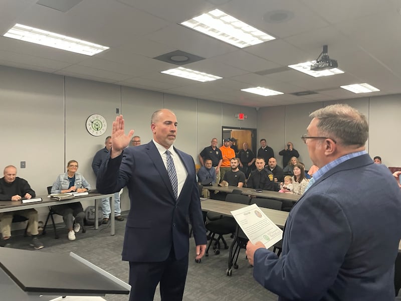 Mendota Police Chief Jason Martin (left) takes the oath of office at the Mendota City Council meeting on Monday, April 21, 2025. Administering the oath of office is Martin's elder brother, La Salle County Circuit Judge Todd L. Martin.