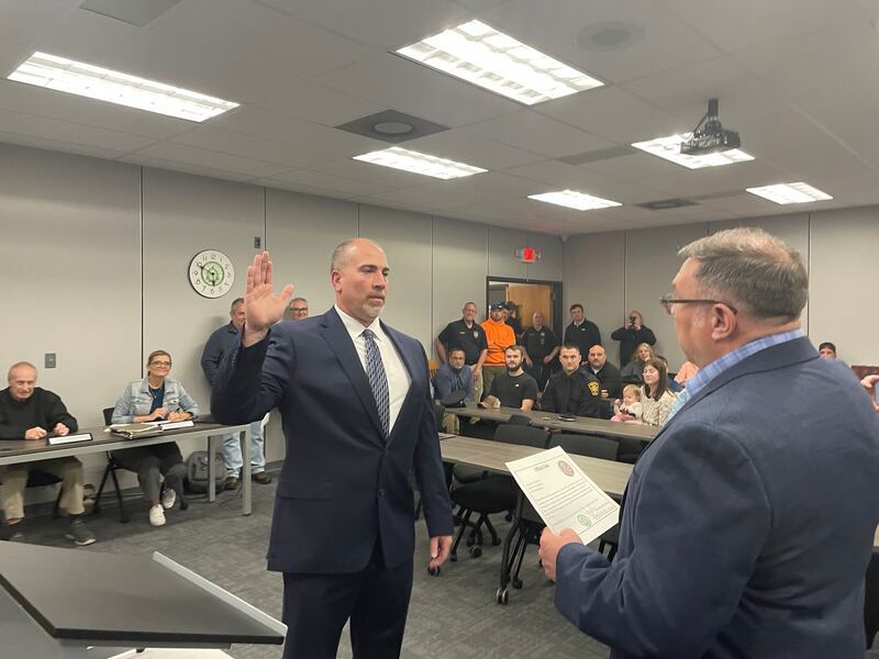Mendota Police Chief Jason Martin (left) takes the oath of office at the Mendota City Council meeting on Monday, April 21, 2025. Administering the oath of office is Martin's elder brother, La Salle County Circuit Judge Todd L. Martin.