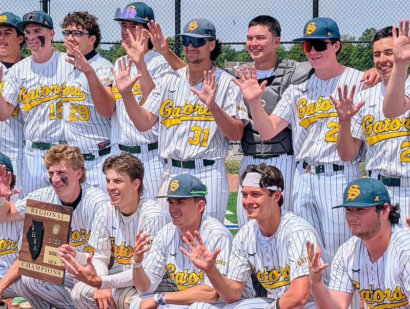 Crystal Lake South's baseball players hold up five fingers and pose for a photo with the championship plaque after beating Carmel 4-3 for their their fifth regional title in a row Saturday, May 30, 2026, at Vernon Hills High School.