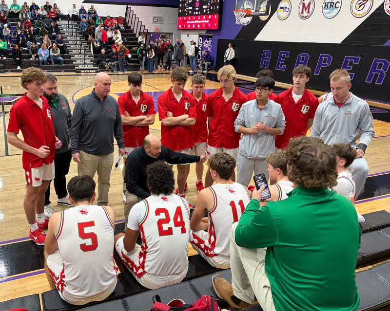 La Salle-Peru head coach John Senica (at center) instructs his Cavaliers during a timeout in their 70-36 win over Bremen on Friday, Dec. 26, 2025, at the Plano Christmas Classic.