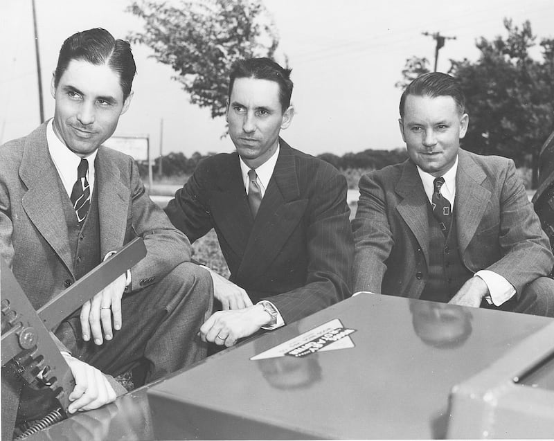 The Woods Brothers – (from left) Keith, Leonard and Mervel – pose for a 1951 photo next to one of their machines at its Oregon facility.