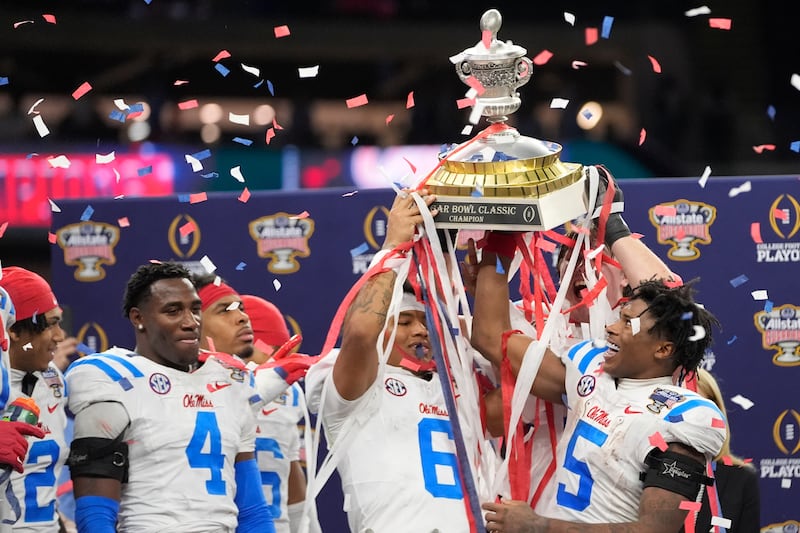 Mississippi players and coach celebrate a win against Georgia after the Sugar Bowl NCAA college football playoff quarterfinal game, Friday, Jan. 2, 2026, in New Orleans. (AP Photo/Gerald Herbert)