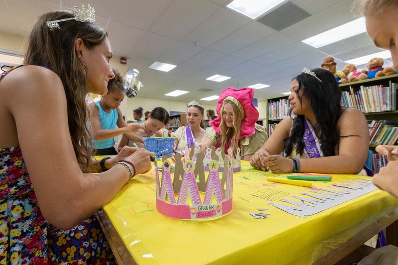 Petunia royalty fills a table Wednesday, July 2, 2025, at the Dixon library helping kids make crafts.