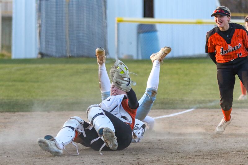 Minooka's Gracie Anderson (13) tags out Joliet Catholic's Callan Kinsella (7) at third to end their softball game between Minooka at Joliet Catholic on Tuesday, April 8, 2025 in Joliet.