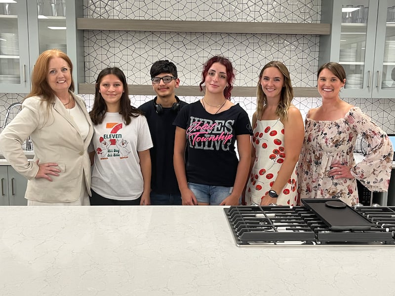Joliet West High School teacher Michelle O'Malley (from left), students Seianna Lozano, Isac Lozano, Vanessa O'Connor and Jasmine Rosenboom and Joliet West culinary instructor Ryann Hager pose in the new cooking classrooms at Joliet West High School on Friday, Aug. 15, 2025.