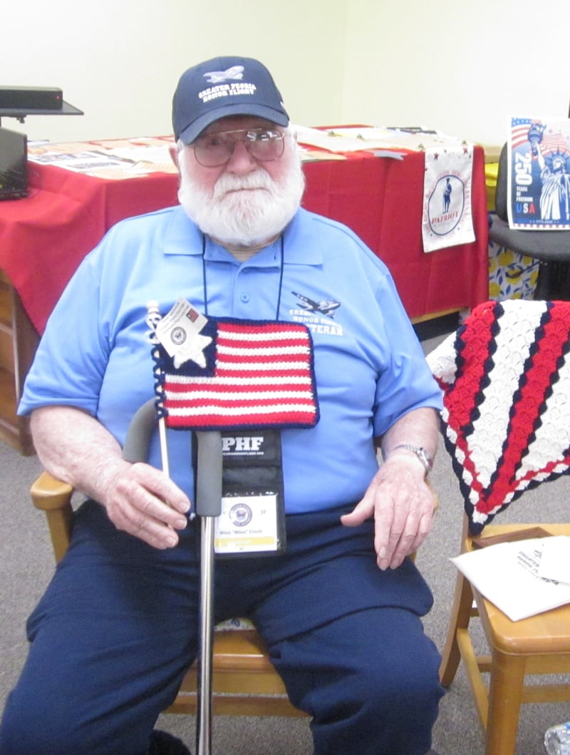 Miles Crook of Putnam County displays some of the items he received during his April 7 Honor Flight trip to Washington, D.C. Seventy-one vets and support staff toured memorials in D.C. and Virginia. Crook shared his experiences with the Chief Senachwine DAR Chapter at its May 2 meeting.