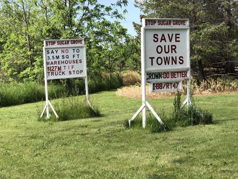 Signs opposing a tax increment financing district and a development proposed for Sugar Grove on Route 47 near Seavey Road.