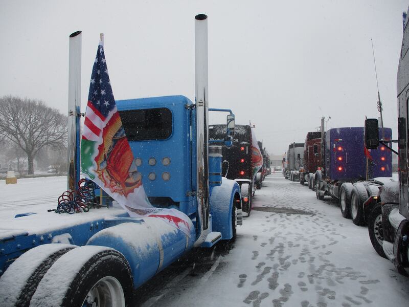 Truck cabs line up in the parking lot outside of Our Lady of Mount Carmel Church on Jackson Street in Joliet before departing on a pilgrimage on Saturday. Nov. 29, 2025