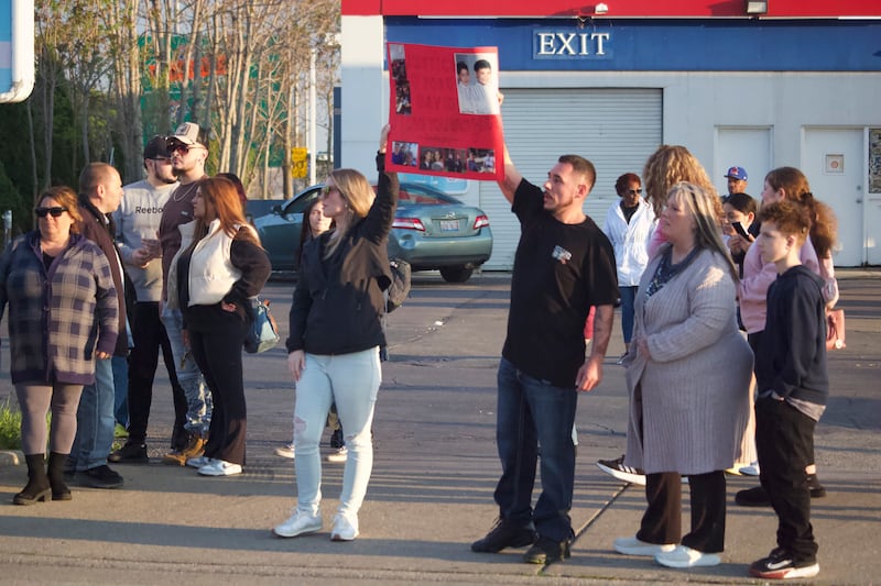 Anthony Malito, the twin brother of David Malito, 39, holds up a sign for a vigil and protest for his brother on Monday, May 5, 2025, at the Shell gas station, 401 S. Larkin Avenue, Joliet.