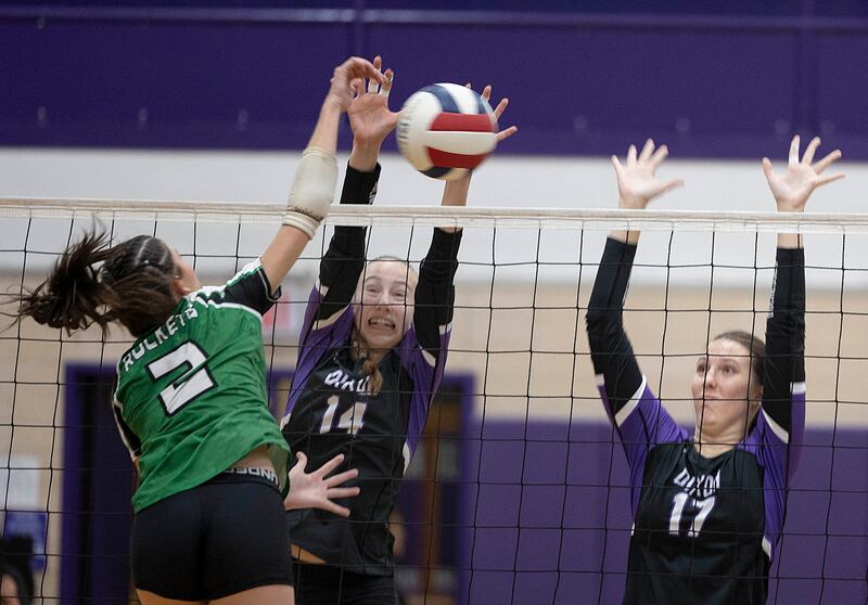 Dixon’s Leah Carlson (left) and Lucy Feick work for the block against Rock Falls Thursday, Sept. 18, 2025.