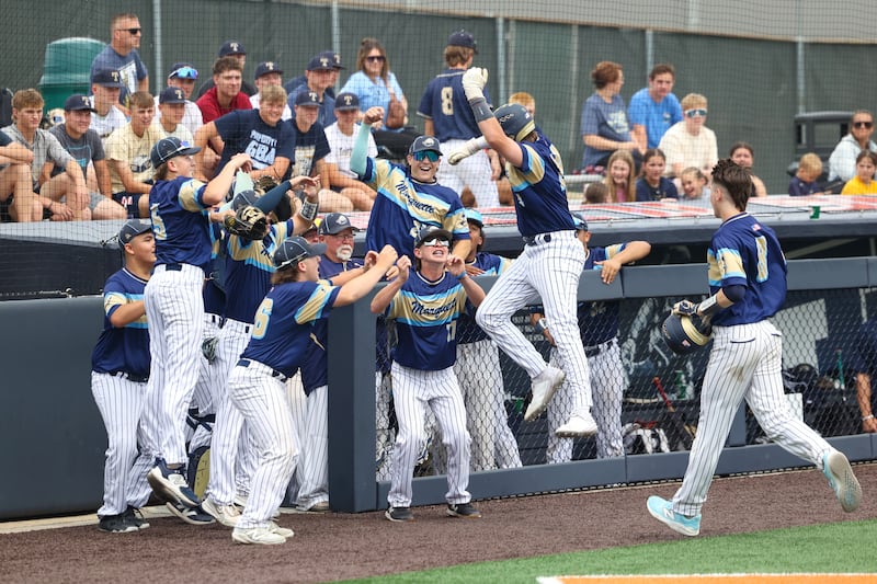 Ottawa Marquette’s Anthony Couch leaps into the dugout in celebration during the Crusaders' 16-1 victory over Lexington in the IHSA Class 1A State semifinal on Friday, June 6, 2025.