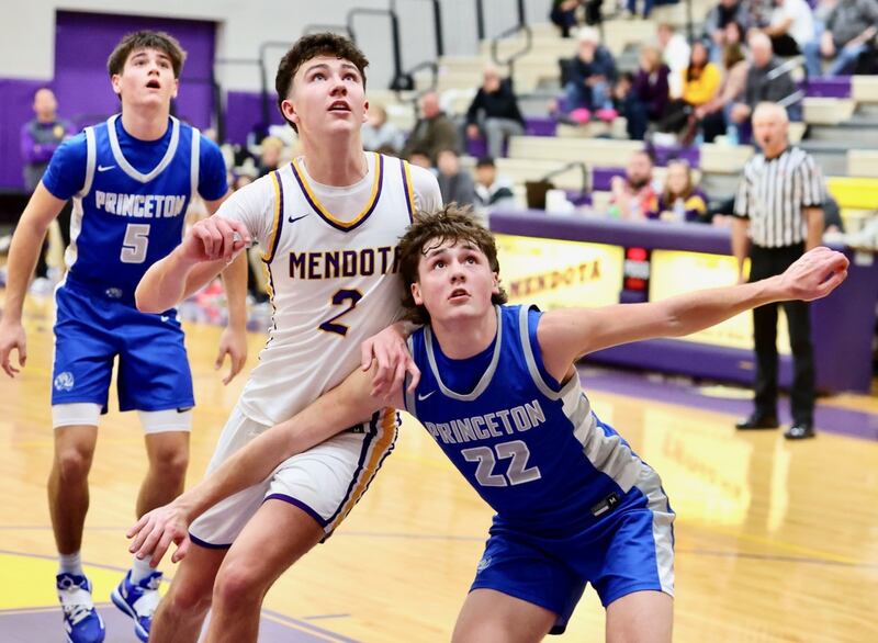 Princeton's Deacon Gutshall boxes out Mendota's Drew Becker in Friday's Three Rivers East game in Mendota. The Trojans won 73-51.