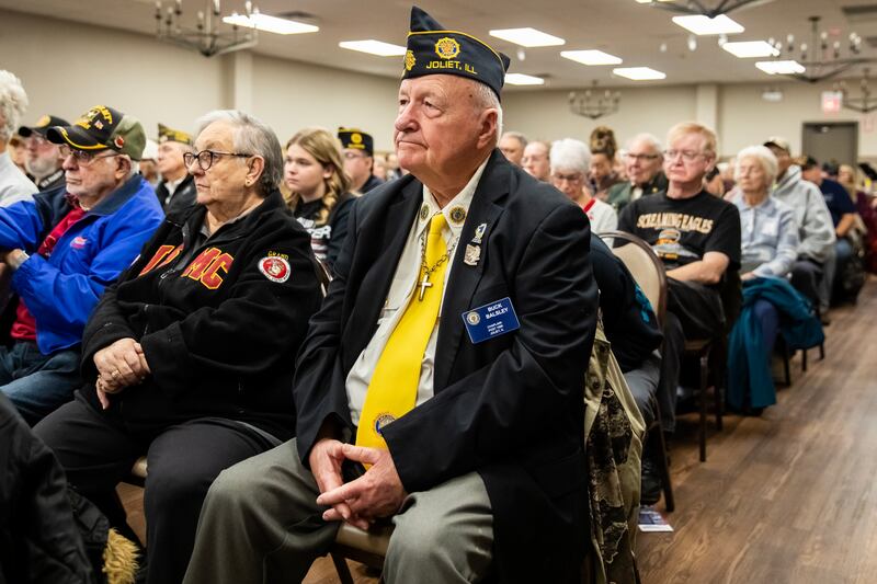 Buck Balsley, Chaplain Post 1080, listen to speakers during a Veterans Day ceremony at American Legion Post 1080 in Joliet on Nov. 11, 2025.