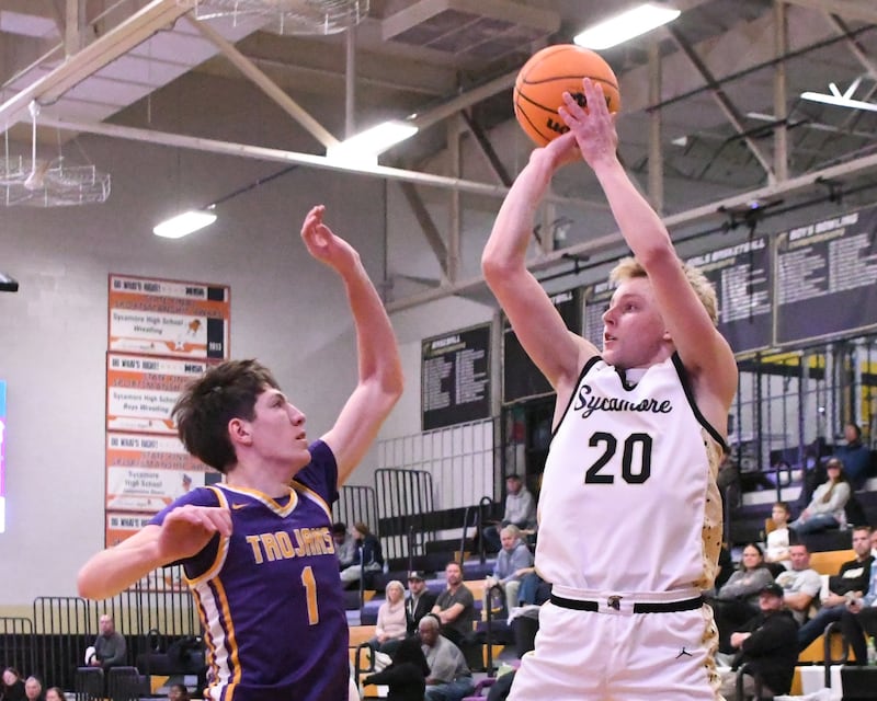 Sycamore's Isaiah Feuerbach (20) takes a shot during the game while being defended by Mendota's Cole Tillman (1) during the game on Wednesday Dec. 17, 2025, held at Sycamore High School.