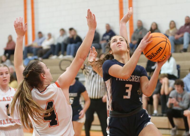 Fieldcrest's Macy Gochanour runs in the lane for a layup over Flanagan-Cornell/Woodland's Aubry Edens during the Falcon-Irish Thanksgiving Tournament this past season at Flanagan High School.