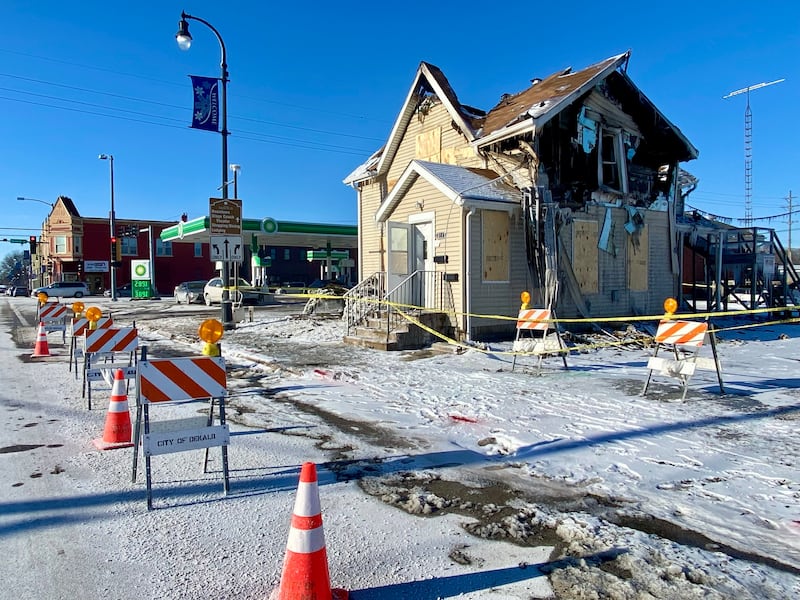 The city of DeKalb has roped off the remains of a two-story duplex on Monday, Jan. 26, 2026, in the 700 block of East Lincoln Highway after the building was destroyed by fire on Saturday, Jan. 24, 2026. Authorities said the accidental fire was caused by someone using a torch in an attempt to thaw frozen pipes in the basement. Traffic cones block the driveway to the building and Eighth Street at East Lincoln Highway on Monday still, two days after the fire.