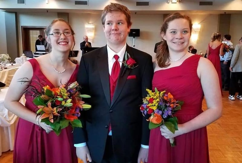 James Haughan at his older sister Melissa's wedding in 2016, standing between his other sister, Monica, (left) and cousin Trisha Carter. Haughen died suddenly at age 18 in 2021 of sudden cardiac arrest. His mother, Elaine Haughan, is working to establish a wind phone in his honor.