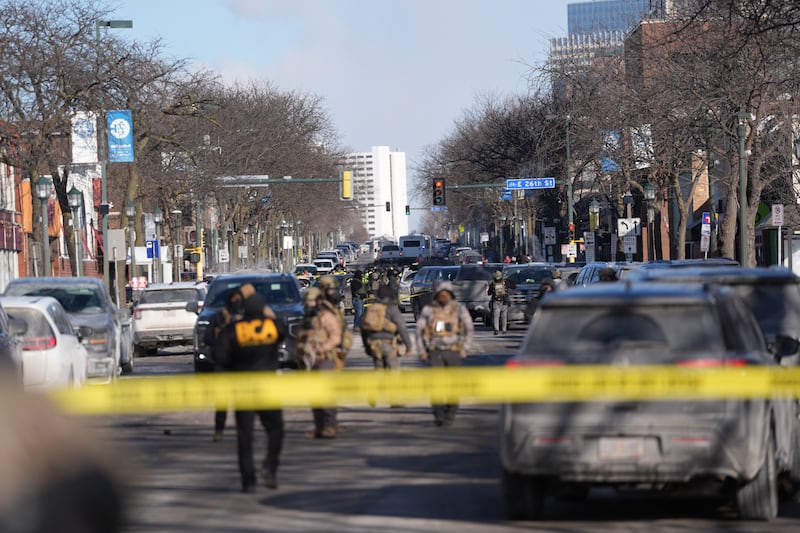 Federal agents stand near the site of a shooting Saturday, Jan. 24, 2026, in Minneapolis. (AP Photo/Abbie Parr)