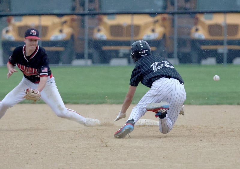 Woodland/Flanagan-Cornell baserunner Reece Pelnarsh (22) prepares to slide on a stolen-base attempt while Henry-Senachwine second baseman Landon Harbinson awaits the throw Tuesday, May 12, 2026, at Woodland School in rural Streator.