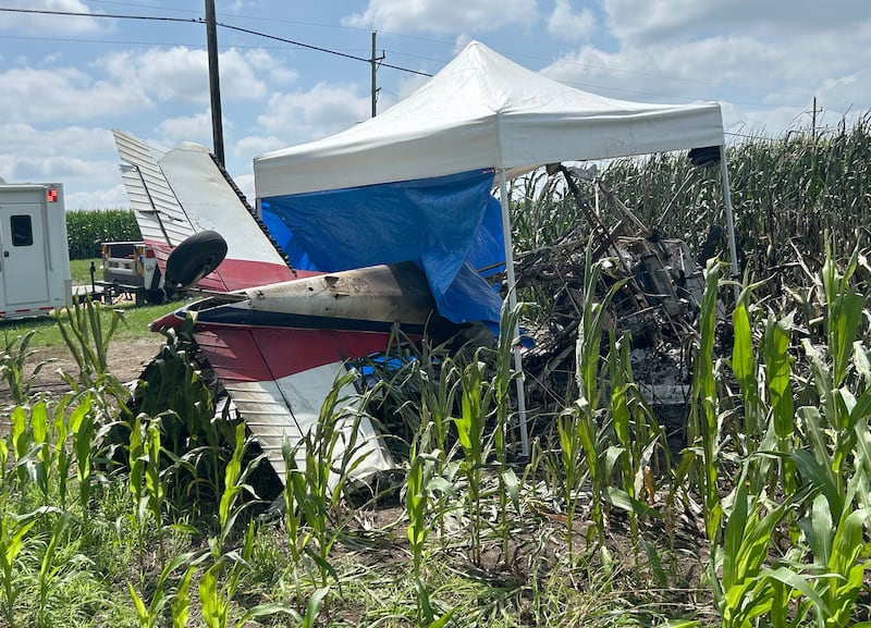 A crop-dusting plane lies upside down in the edge of a cornfield along Illinois Route 64 near the Ogle County Airport between Oregon and Mt. Morris on Tuesday, July 22, 2025. The pilot of the plane was killed after hitting power lines near the airport. A section of Illinois Route 64 remained closed between Rock and Ridge roads as ComEd crews worked to repair damage to poles and lines. This photo was taken after the pilot was removed from the wreckage.