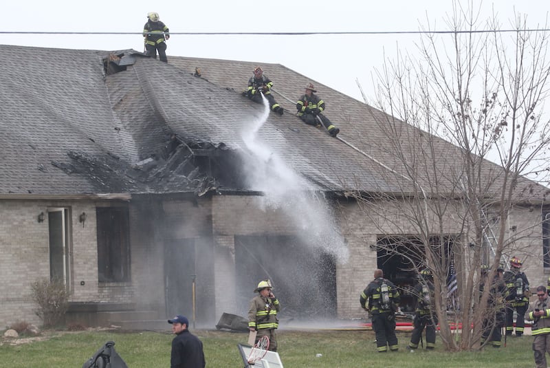 Firefighters spray water on a structure fire in the 600 block of U.S. Route 6 on Tuesday, April 1, 2025 in La Salle. Fire departments from Peru, La Salle, Utica, Troy Grove, Spring Valley, Wallace and Oglesby were dispatched just before 2:30 to a one-story dublex home.