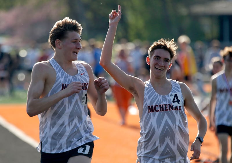 McHenry’s Myles Wagner and Nate Martin finish together in the 3200 meters run on Thursday, April 23, 2026, during the McHenry County Track and Field Meet at McCracken Field in McHenry.