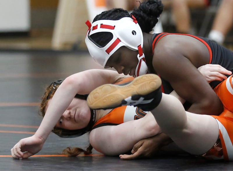 Huntley’s Janiah Slaughter controls McHenry’s Kaitlynn Mann during the 105-pound match of a Fox Valley Conference girls wrestling match Thursday, Jan. 11, 2024, at McHenry High School.