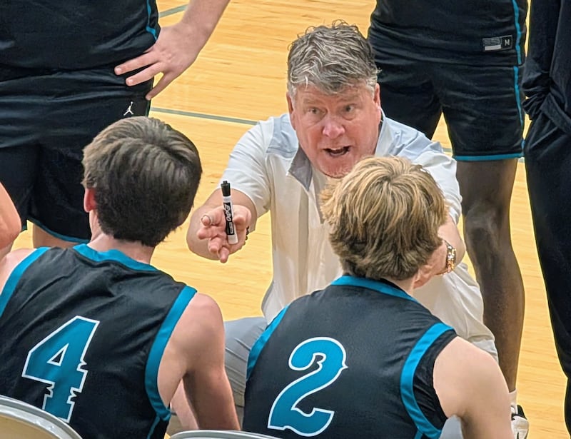 Woodstock North boys basketball coach Tim Paddock talks to his team during a timeout against Hononegah in the Hoops for Healing Classic on Wednesday, Nov. 26, 2025, at Woodstock North.