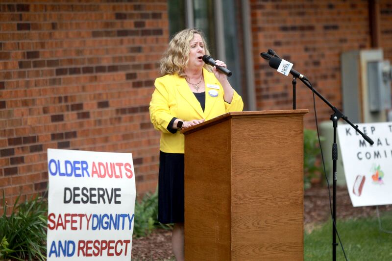 Marla Fronczak, chief executive officer of AgeGuide, speaks during a rally against cuts to the federal Older Americans Act at the Senior Services Associates community center in Yorkville.