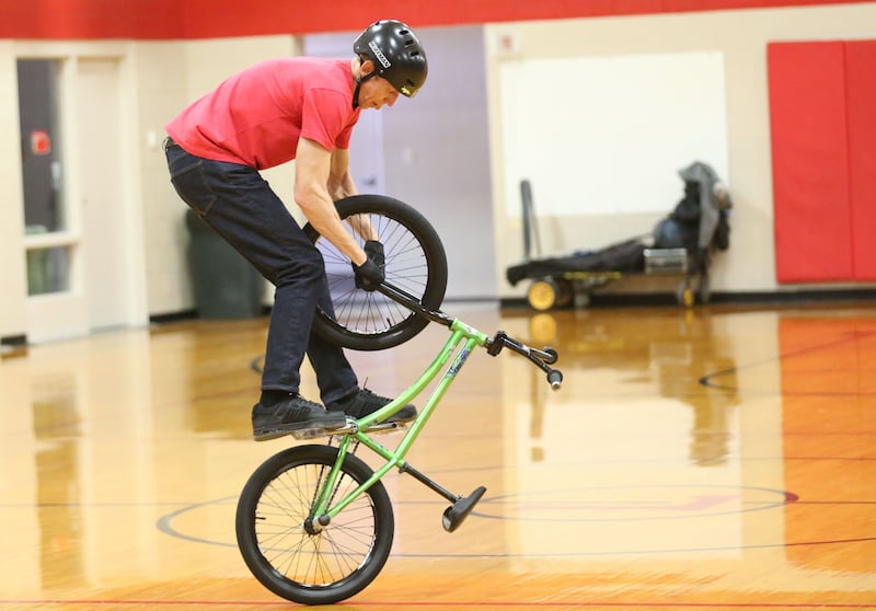 Matt Wilhelm, a national BMX Rider, Guinness World Record holder and America’s Got Talent semi-finalist rides a bicycle upside down during an assembly on Monday, Jan. 13, 2024 at Ladd Grade School. Wilhelm, a three-time X Games medalist and two-time national champion, is a native to Oak Lawn. Wilhelm was bullied as a child. Today, he presents a strong message while speaking to children while focusing on kindness, positivity and the differences that one person can make.