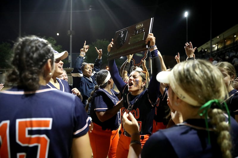 Oswego’s Kiyah Chavez hoists the plaque as she and her teammates celebrate their Class 4A Benedictine Supersectional win over Marist on Monday, June 9, 2025 in Lisle.