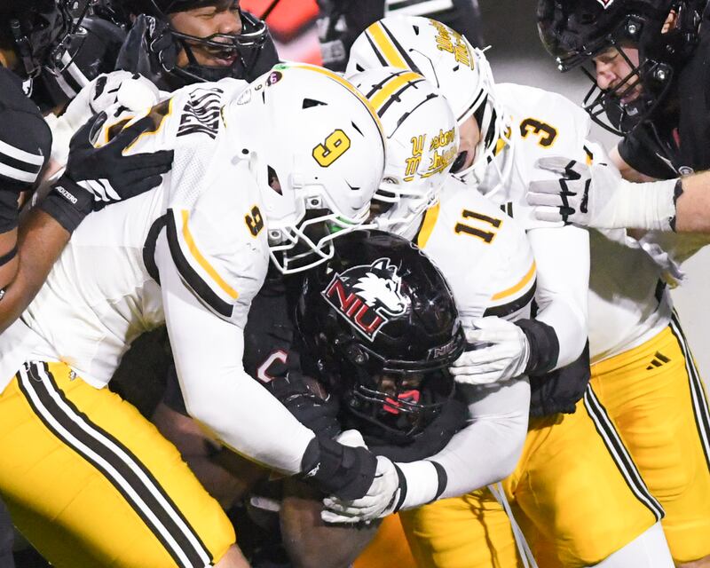 Northern Illinois University's running back Chavon Wright (10) tries to gain extra yards as he is surrounded by Western Michigan defenders on Tuesday Nov. 18, 2025, held at Huskie Stadium in DeKalb.