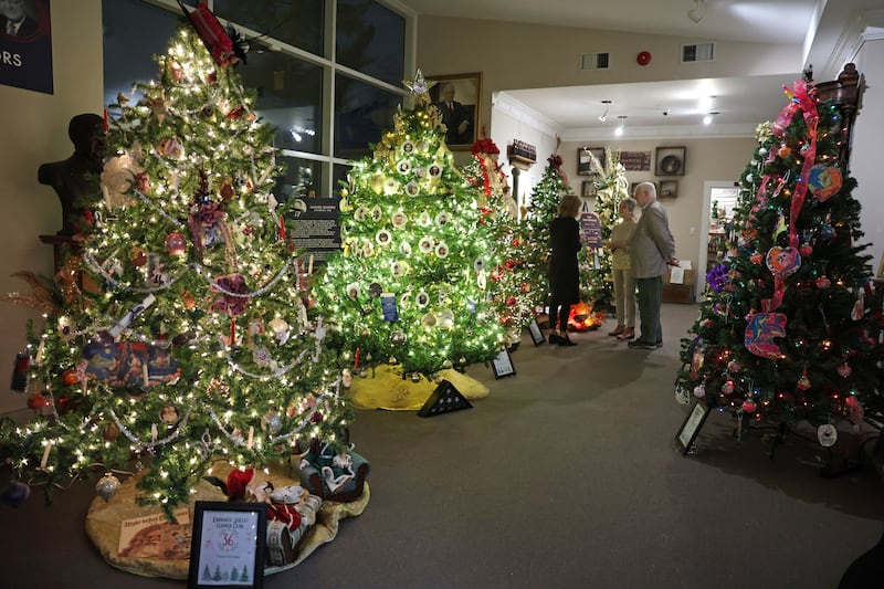 Attendees admire trees at the Kankakee County Museum during the kickoff event for the 47th annual Gallery of Trees on Wednesday, Dec. 3, 2025.
