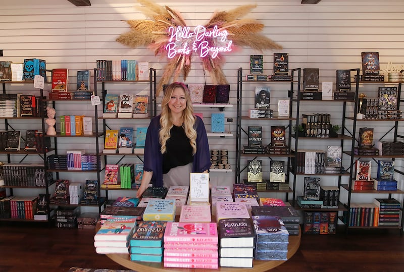 Tina Lawrence, the owner of Hello Darling Books and Beyond, inside her tiny shop on Friday, April 25, 2025, at the McHenry Riverwalk Shoppes. The shops open for the 2025 season on May 2.